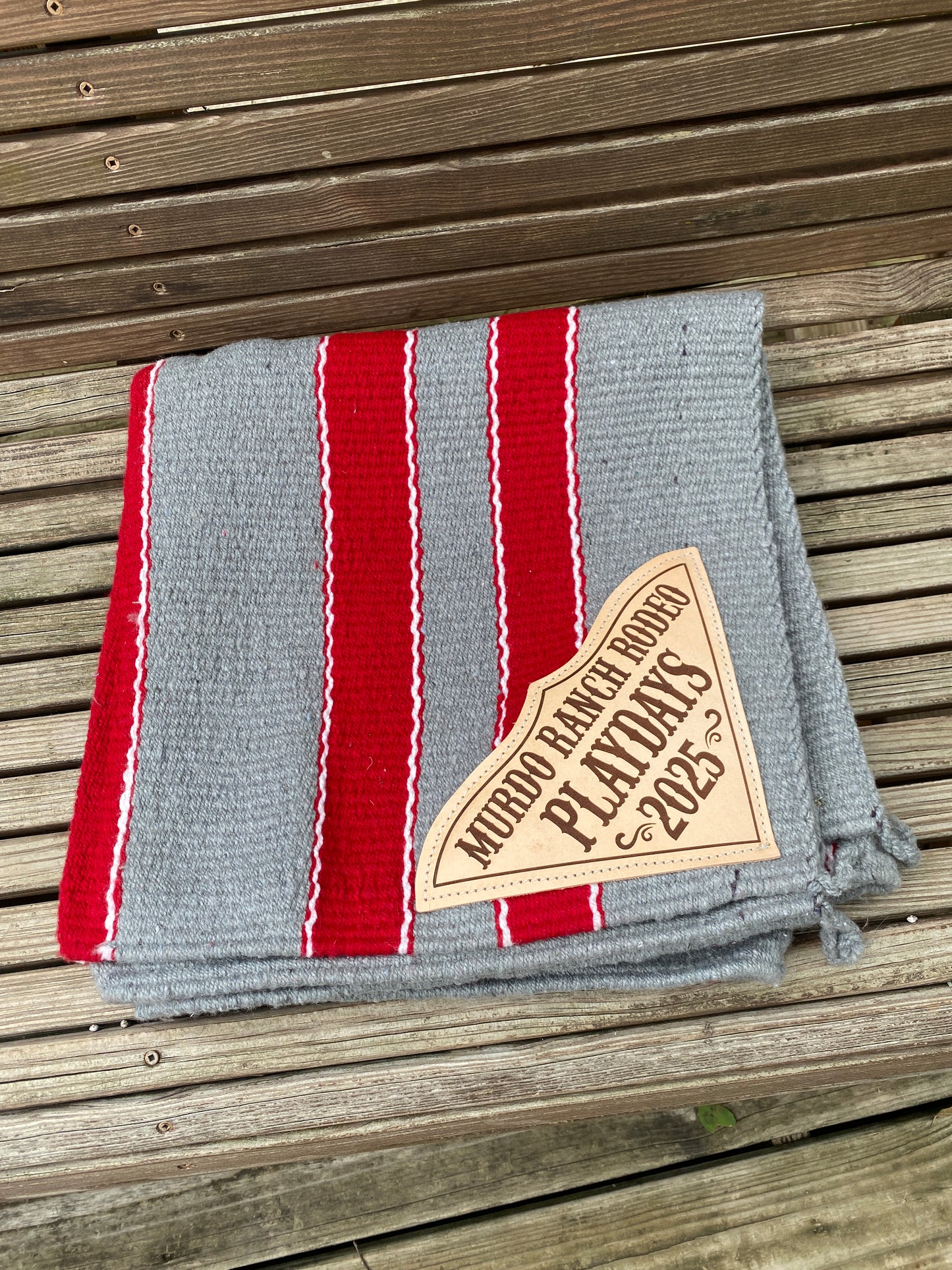 folded color band saddle blanket red and gray with custom leather corners