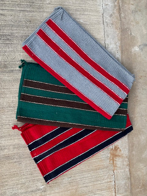Three striped saddle blanket samples in red, gray, and green