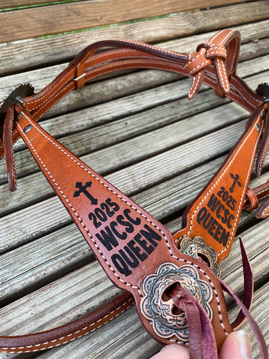 Brown leather bridle with engraved rodeo queen text on the cheeks