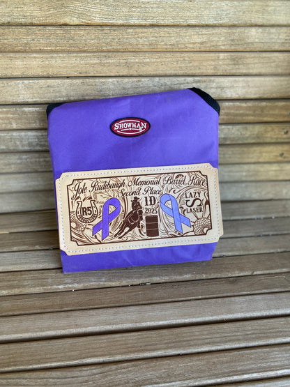 Custom laser engraved award hay bag for rodeos and horse shows folded on a wooden bench