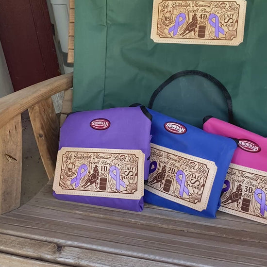 Video of award hay bags displayed on a rustic wooden rocking chair with a butterfly landing beside the bags and flapping its wings