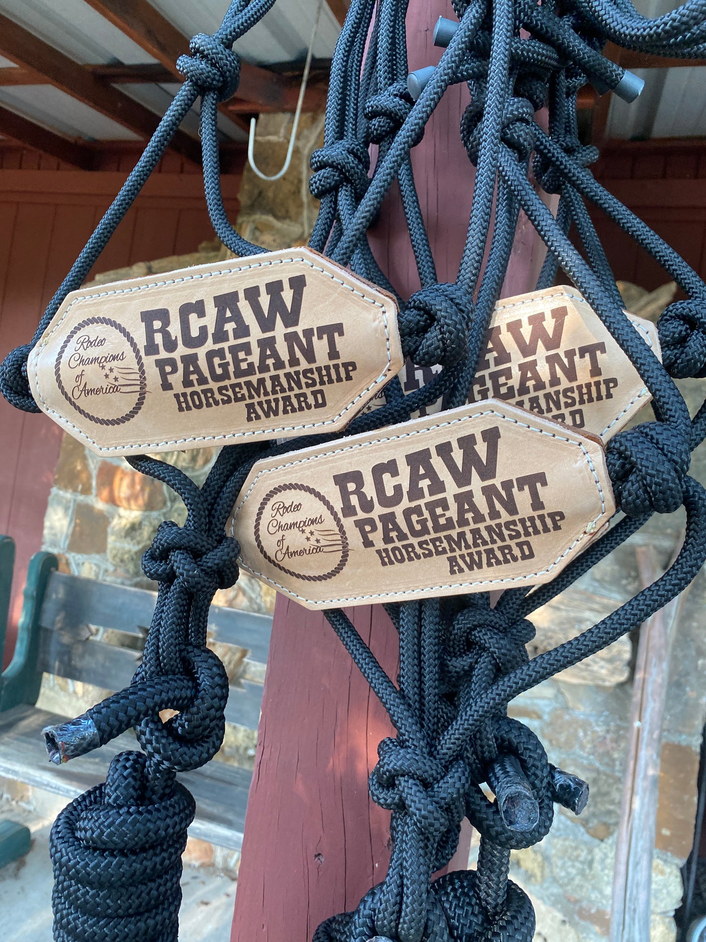 Three leather rope bronc nosebands with 'RCAW Pageant' horsemanship award branding