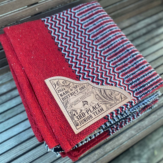 zigzag pattern saddle blanket double weave with custom engraved leather corner showcasing a riding club's logo.